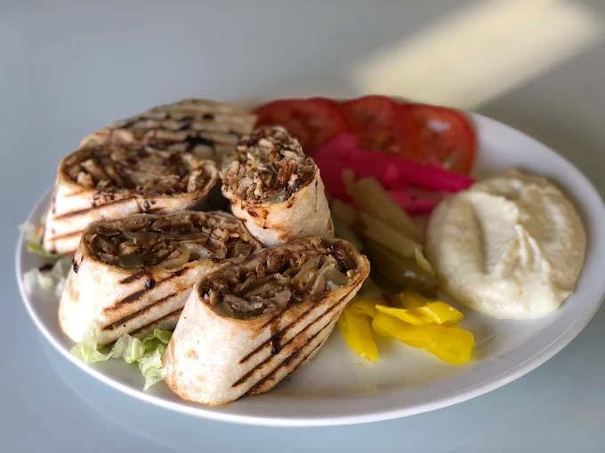 Chicken shawarma platter with rice, hummus and garlic sauce at Empire Shawarma Calgary NW